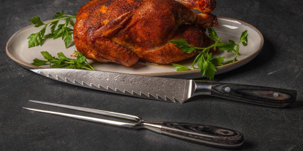 The Messermeister Avanta Damascus Carving set with a roasted chicken